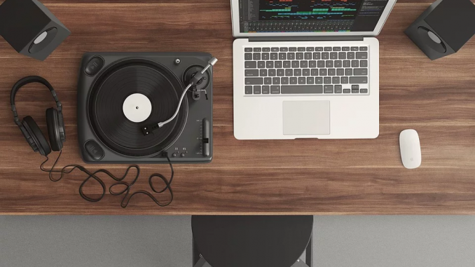Laptop with a digital turntable on wooden desk
