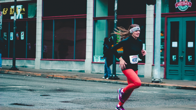 Woman running outside with red pants