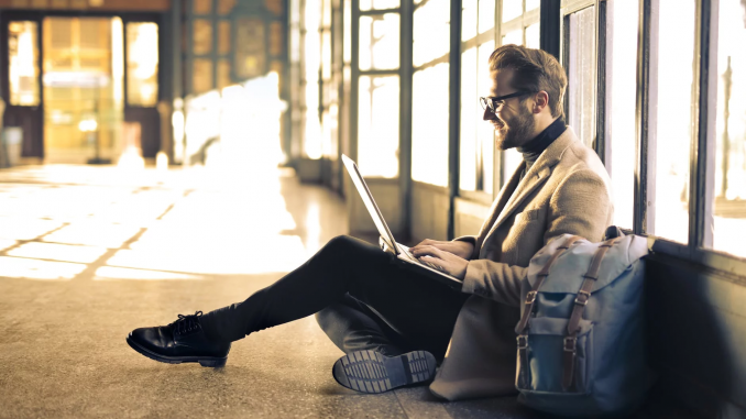 Happy Man Smiling at Laptop